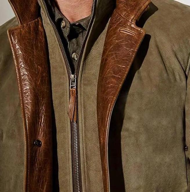 Close-up of a brown leather jacket with a zipper on a neutral background